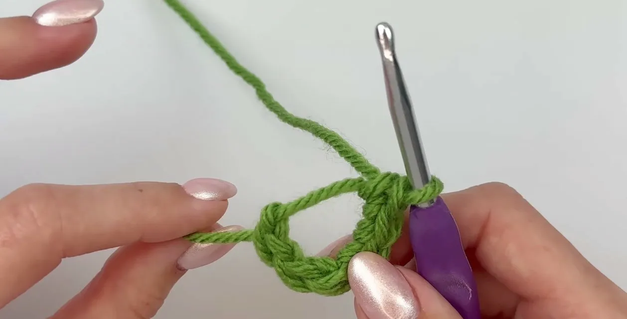 Crocheting into the magic circle with the first stitches visible