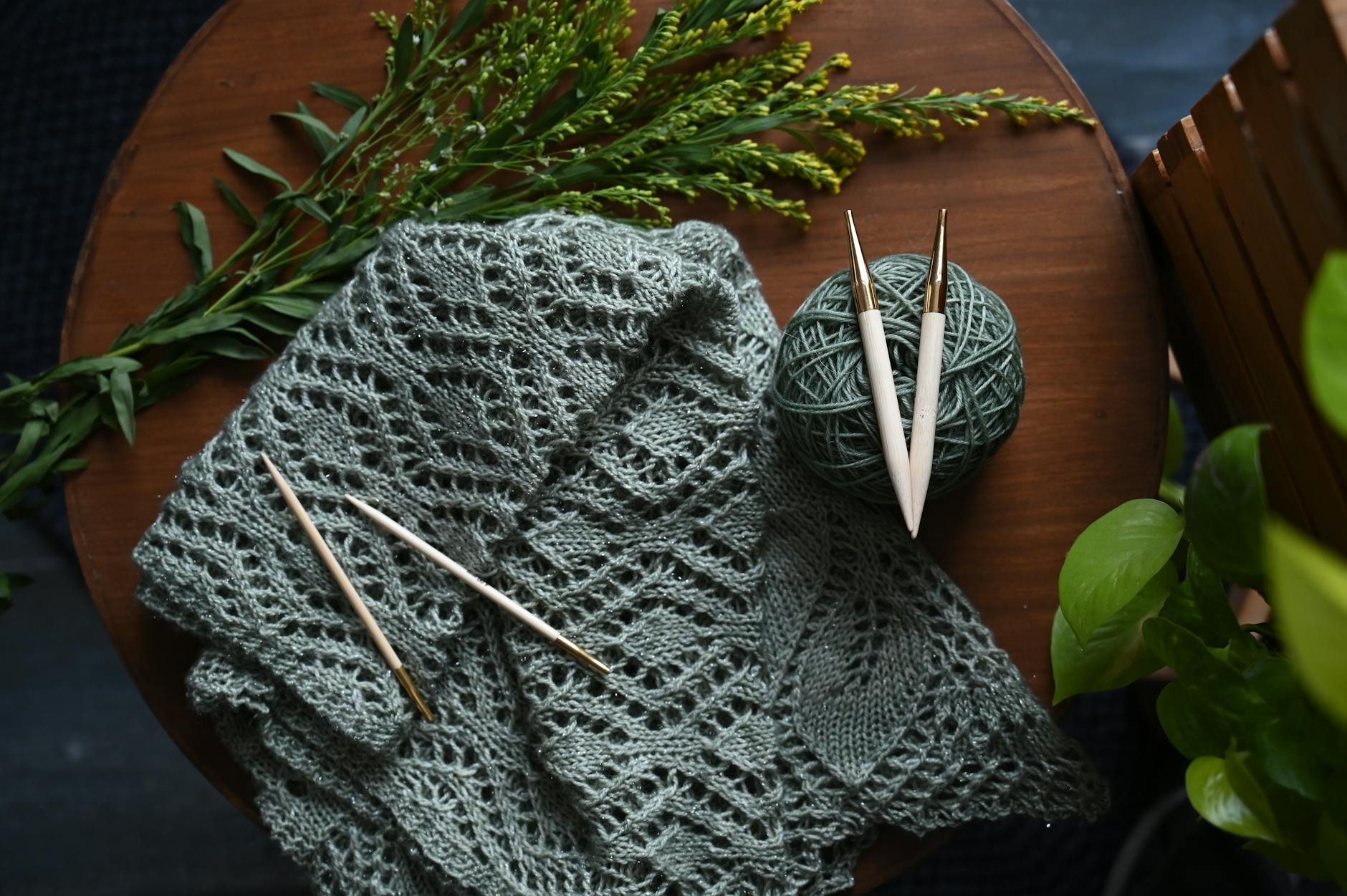 Green knitted shawl with crochet hooks for hooded shawl crochet pattern