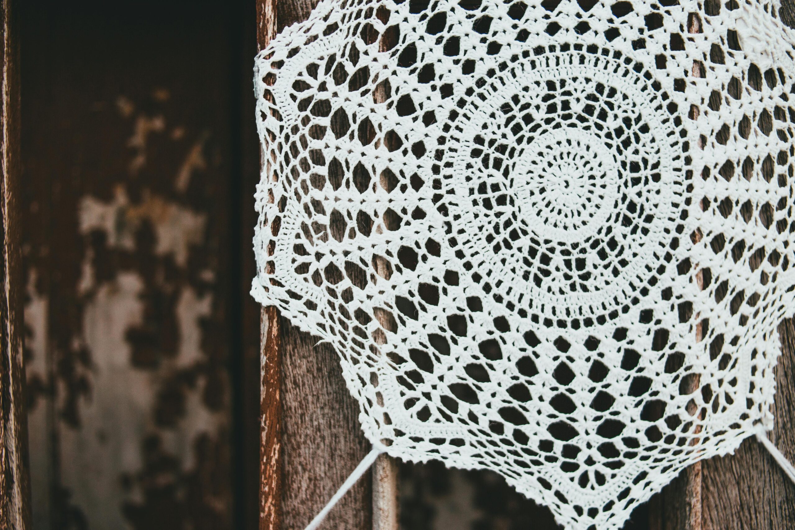 crochet doily pattern for beginners featuring a simple round cotton doily on a wooden table