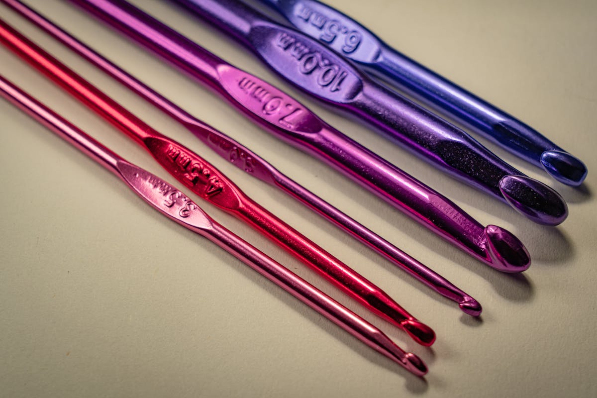 colorful crochet hooks set on light background