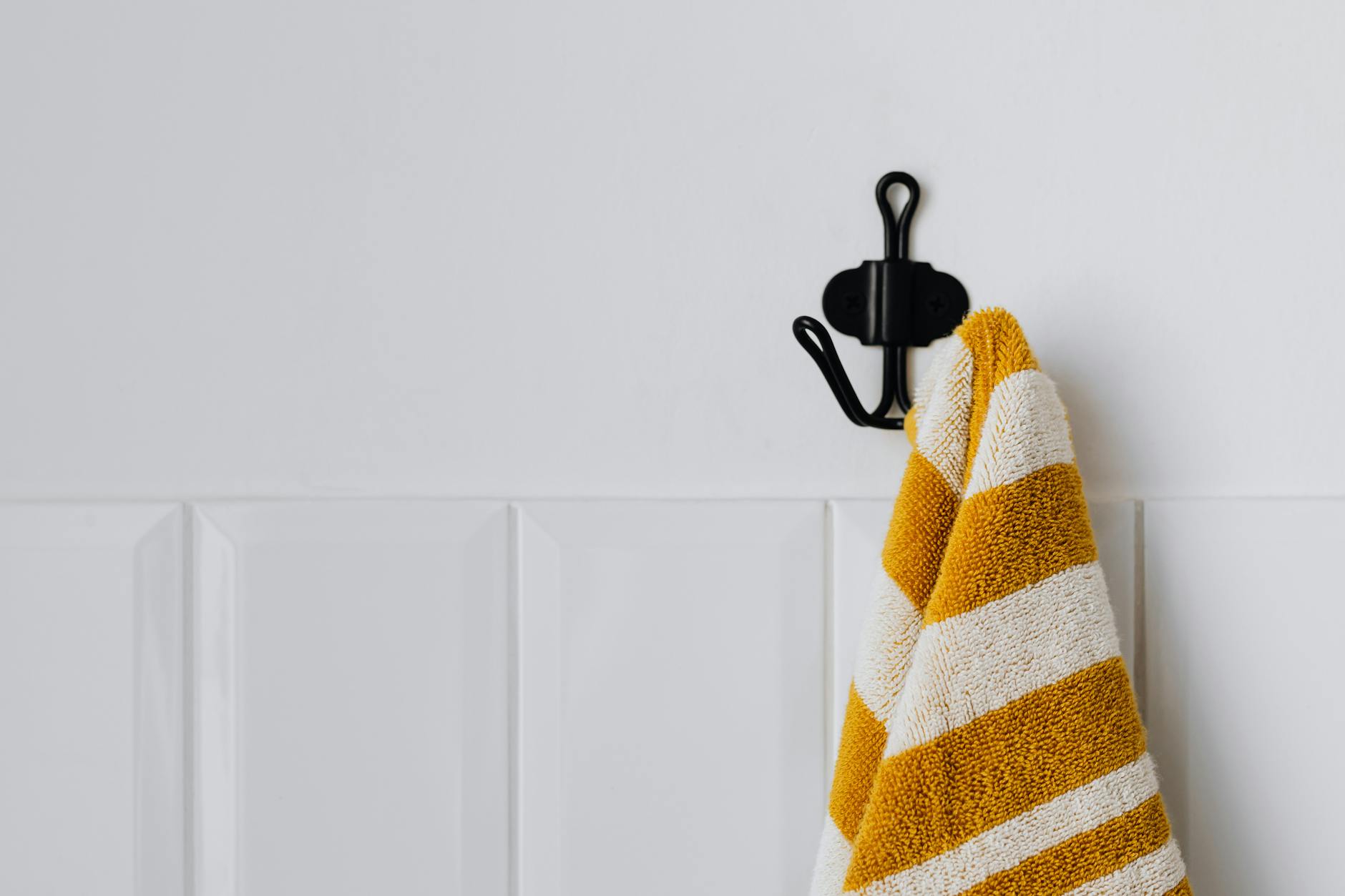 crocheted dish towel with hanging loop on a hook in a minimalist kitchen