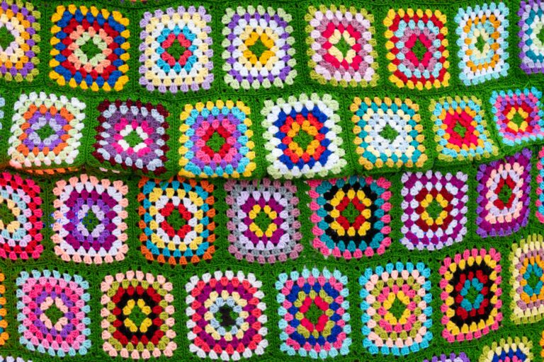 crochet border patterns on a colorful afghan blanket with yarn balls and crochet hook