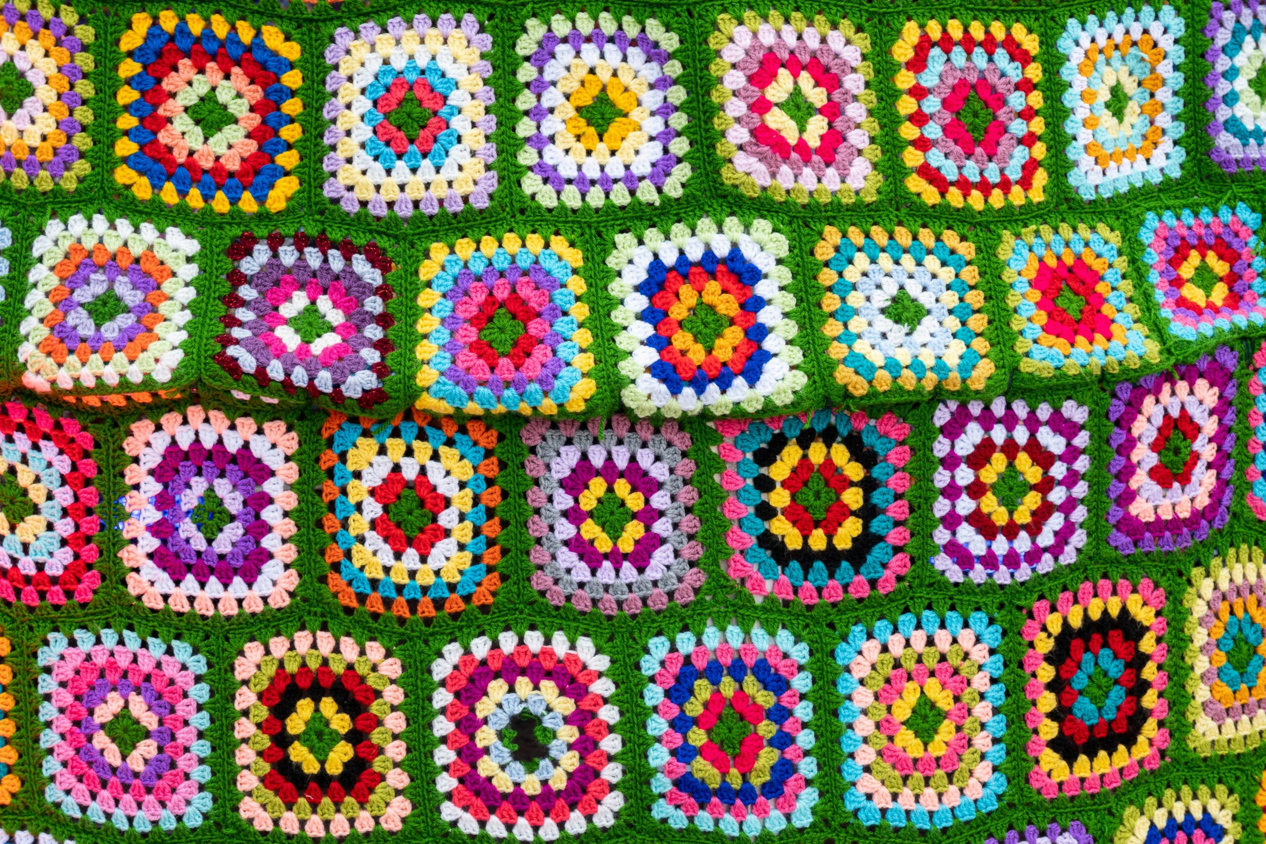 crochet border patterns on a colorful afghan blanket with yarn balls and crochet hook