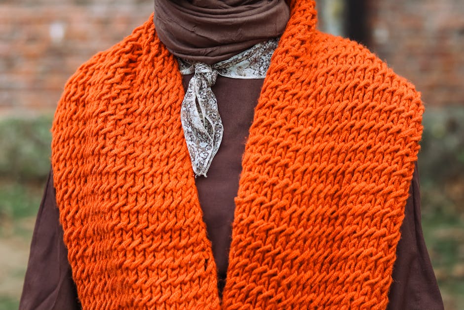 orange knit scarf texture close up showing beautiful crochet scarf stitch detail