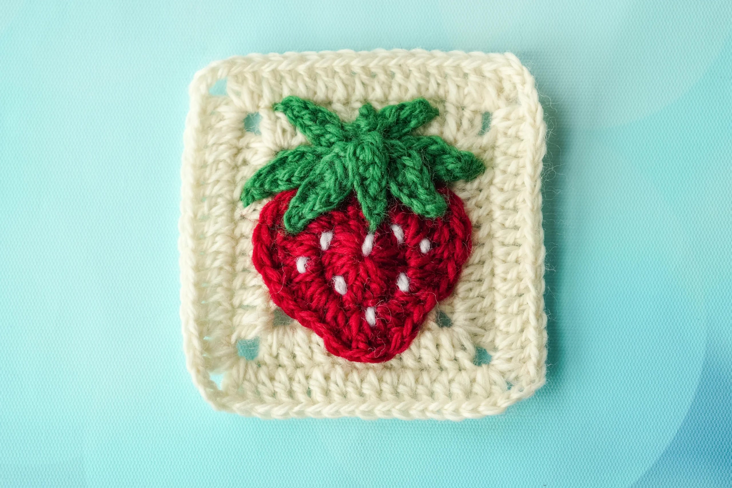 Strawberry-themed 3D granny square patterns showing dimensional fruit motifs