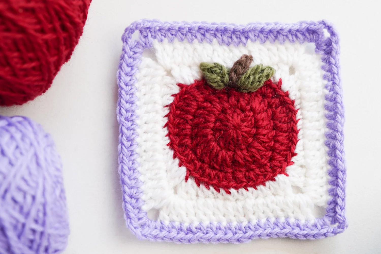 Apple-themed 3D granny square patterns with dimensional crochet fruit designs