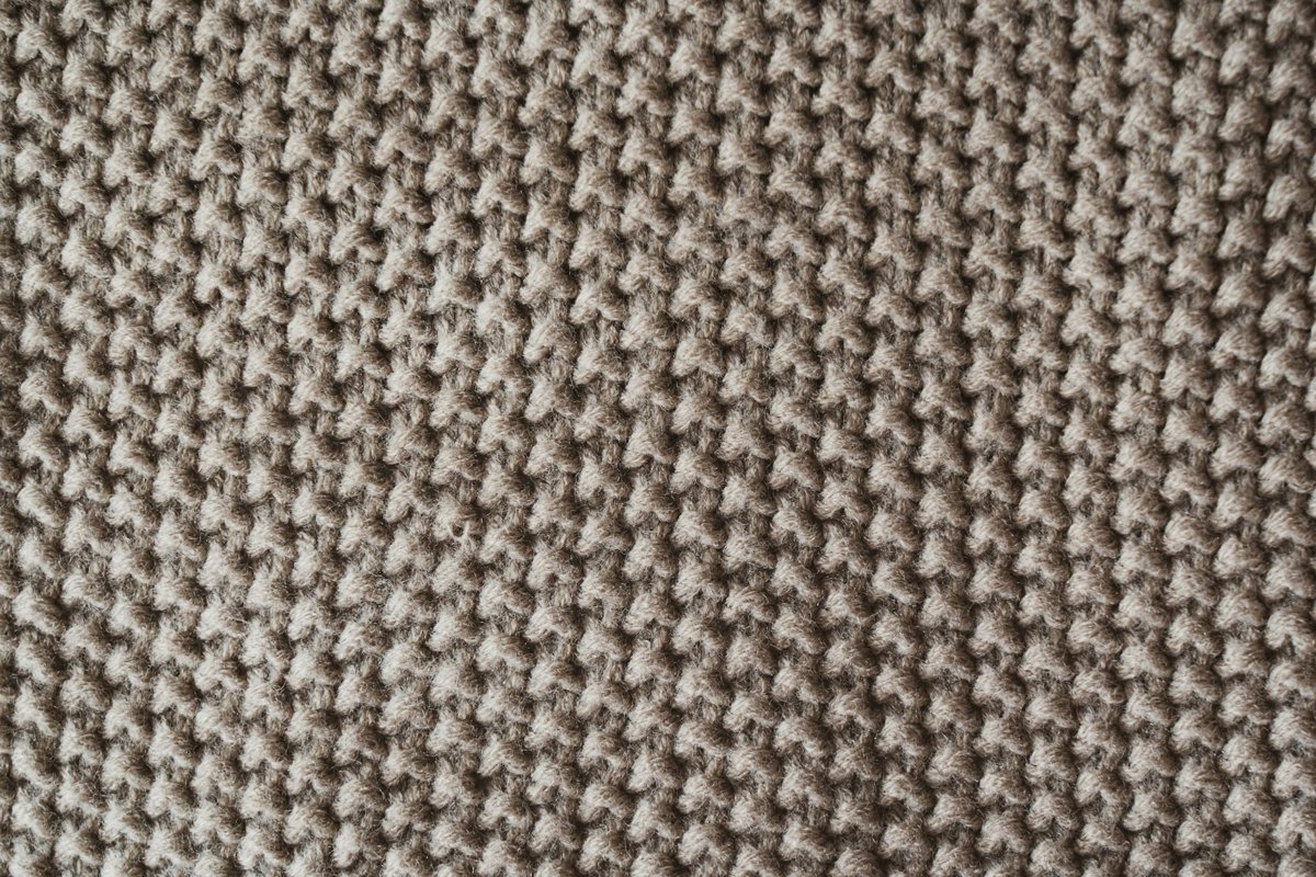 Detailed close-up of textured knitted wool fabric for quick crochet gift projects