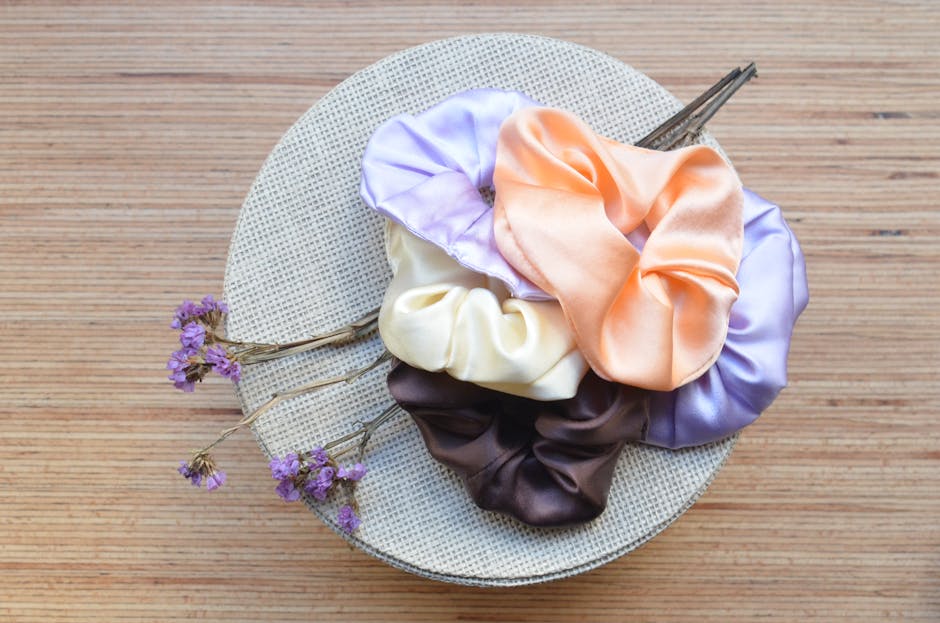 Assorted hair ties and accessories styled alongside a handmade crochet scrunchie