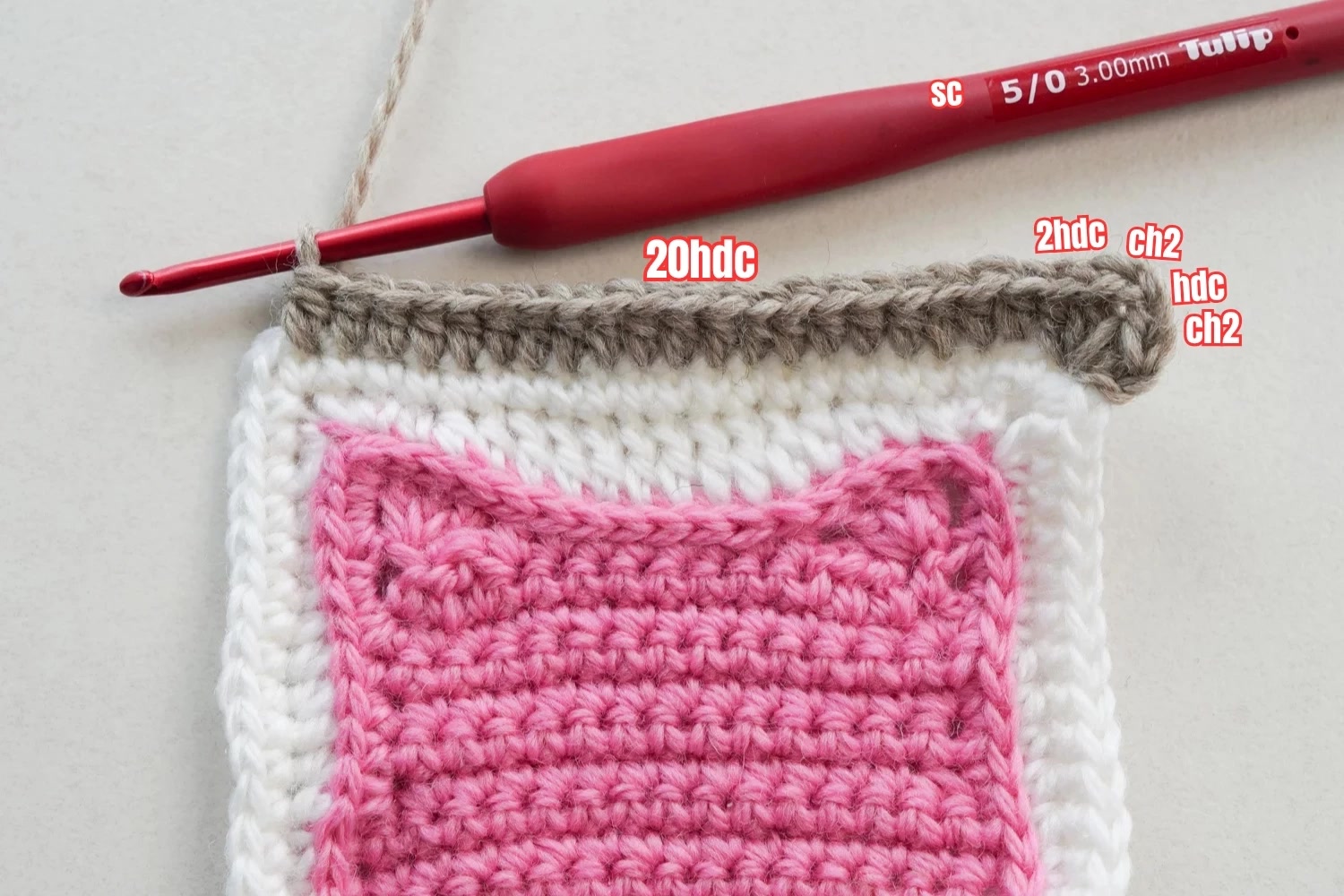 Detail of cat granny square pattern showing ear construction and face features