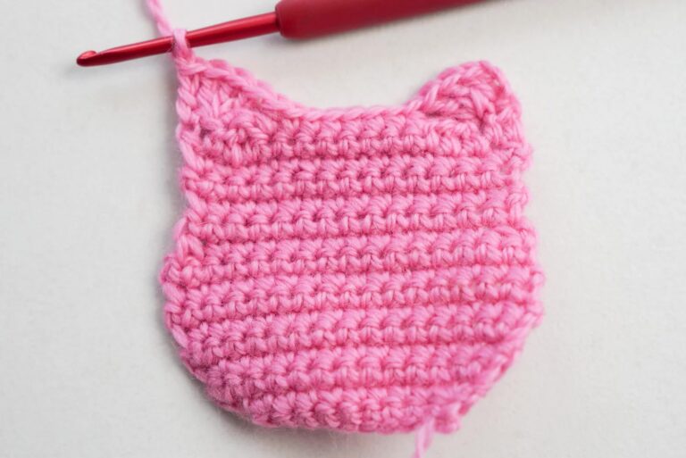 Cat granny square crochet pattern showing a cute round cat face in the center of a traditional granny square