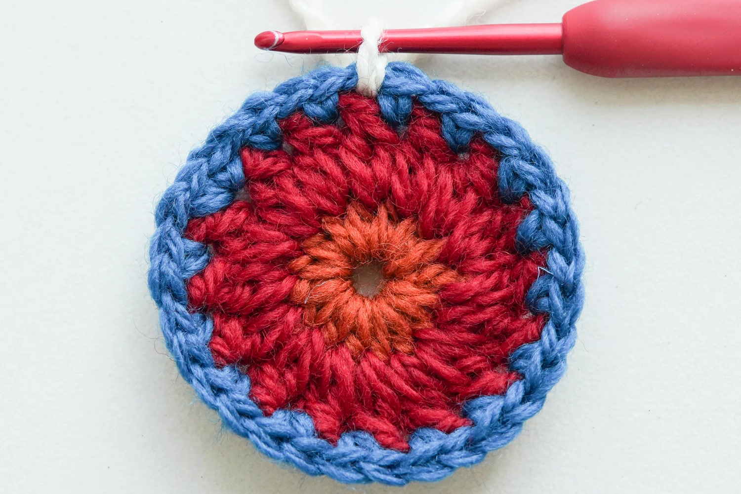 Close-up detail of folk flower medallion granny square petal layers