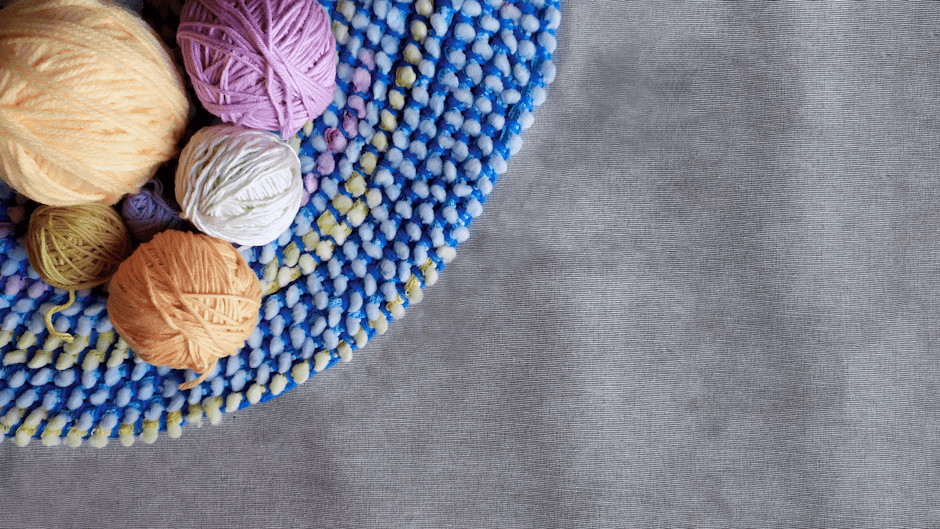 Vibrant yarn balls displayed on a crochet rug pattern mat perfect for home decor crafting projects