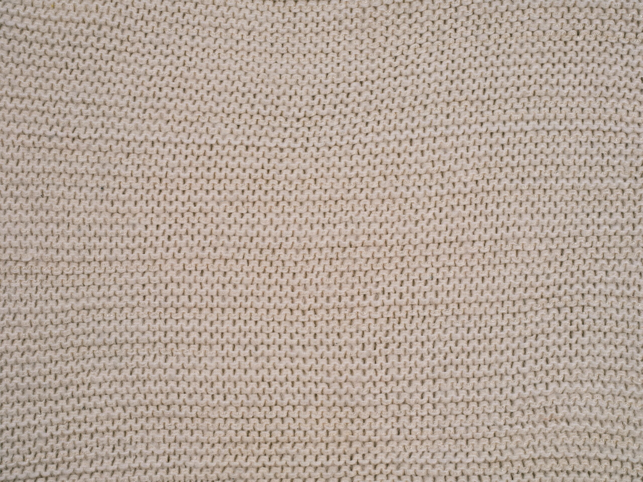 Beige knitted fabric stitch texture close-up for crochet lounge pants pattern inspiration