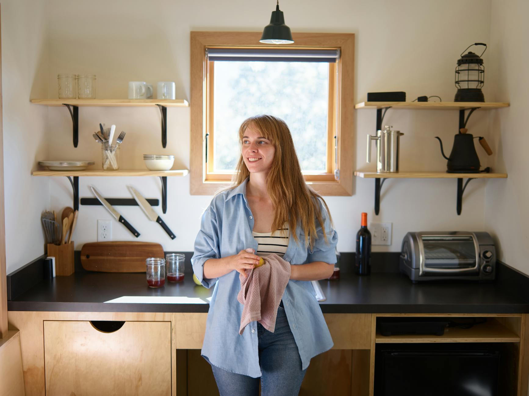crochet dishcloth patterns - Charming smiling young blonde in casual wear leaning on kitchen counter with dishcloth and ap...