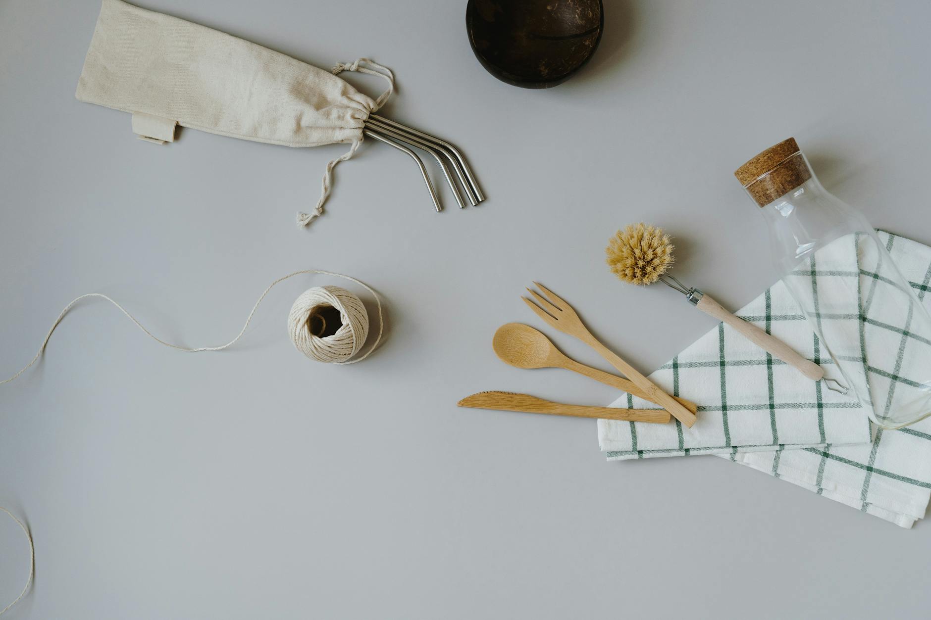 crochet dishcloth patterns - From above of composition of wooden cutlery with transparent bottle near dish washing brush on k