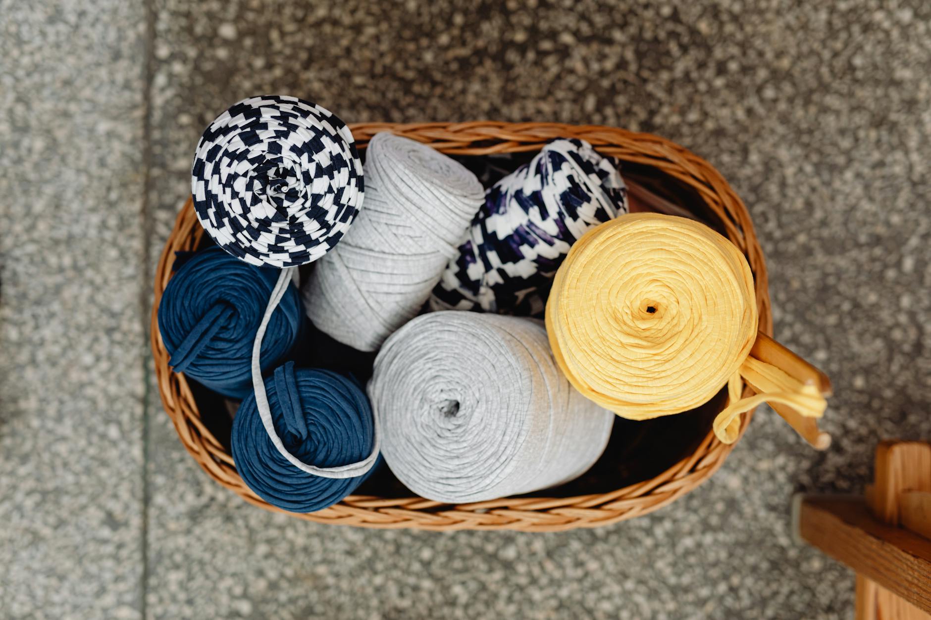 crochet basket patterns guide - Top view of a woven basket with colorful yarn spools, perfect for knitting enthusiasts.