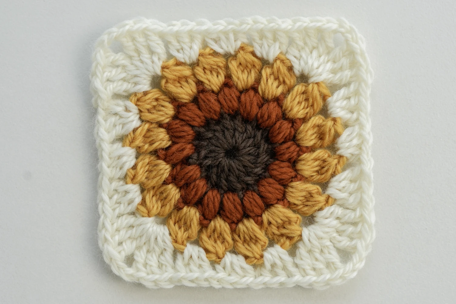 Finished classic sunburst granny square in traditional sunflower colors