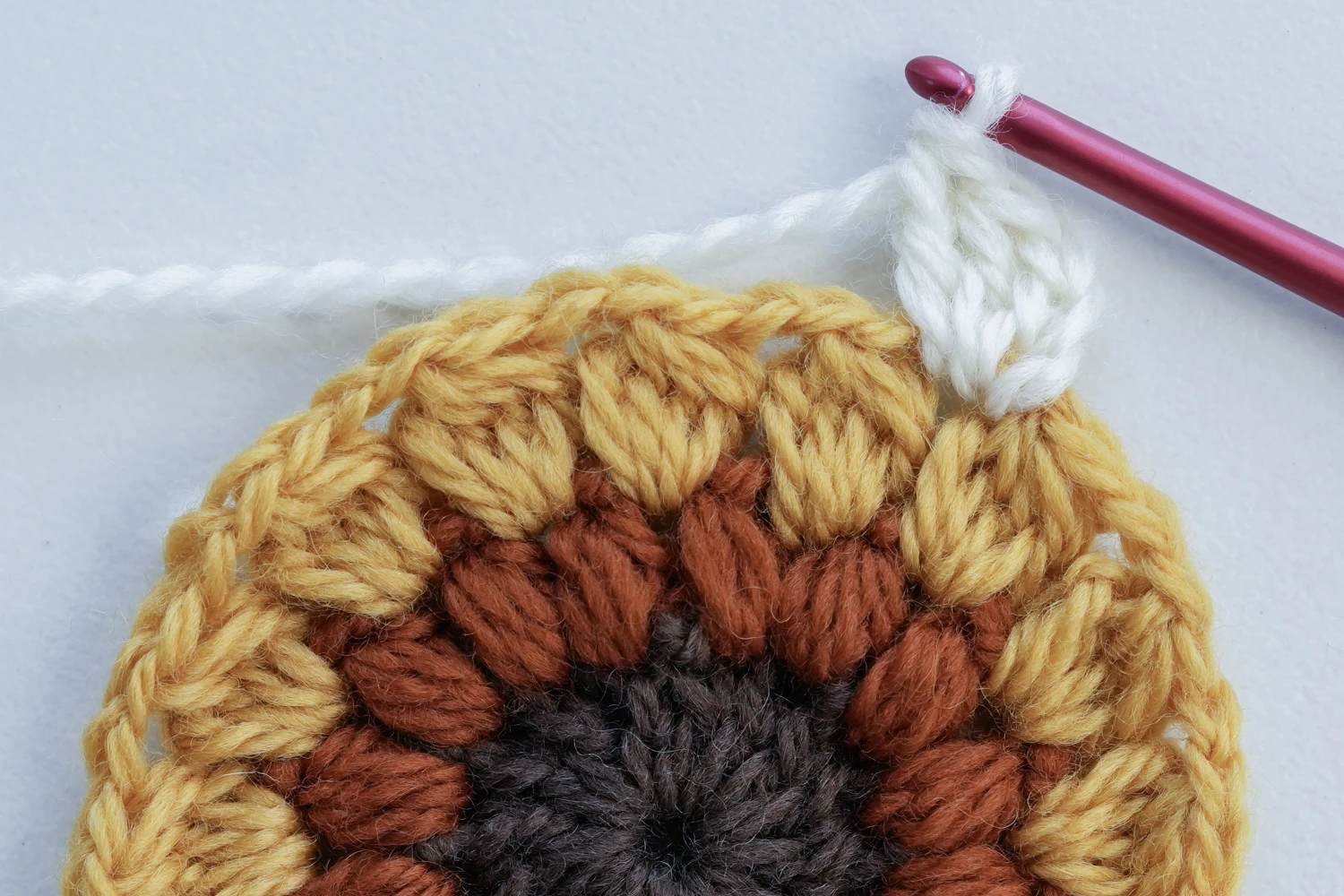 Vintage sunburst granny square Round 5 BPdc border creating textured frame