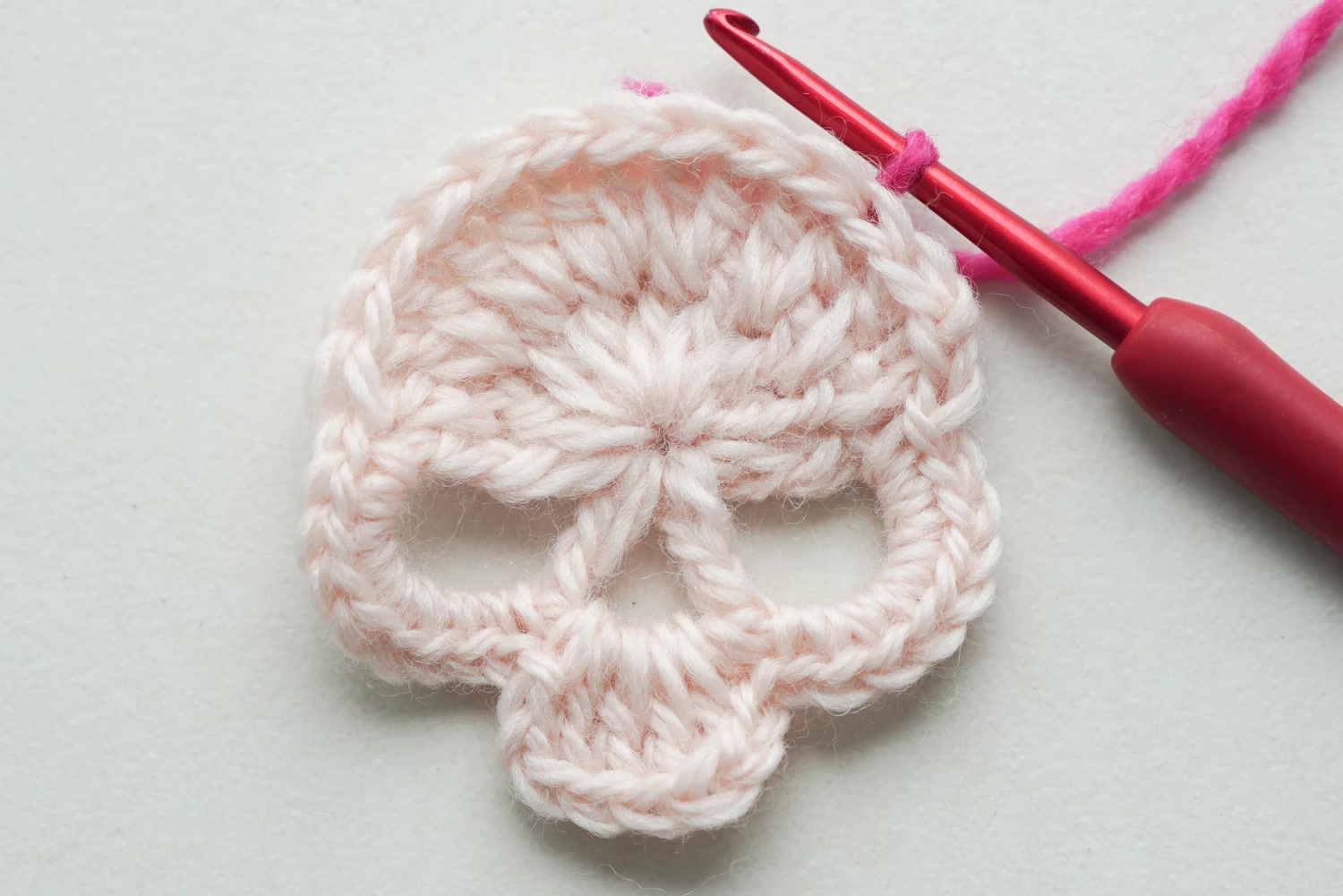 Detail of skull granny square pattern showing clean colorwork and stitch definition
