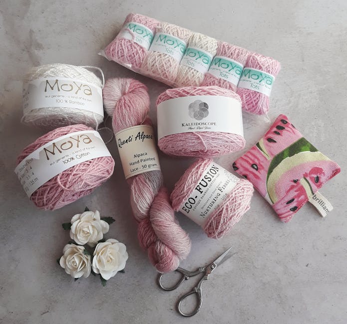 Assorted yarns and crochet tools arranged for a summer top crochet project
