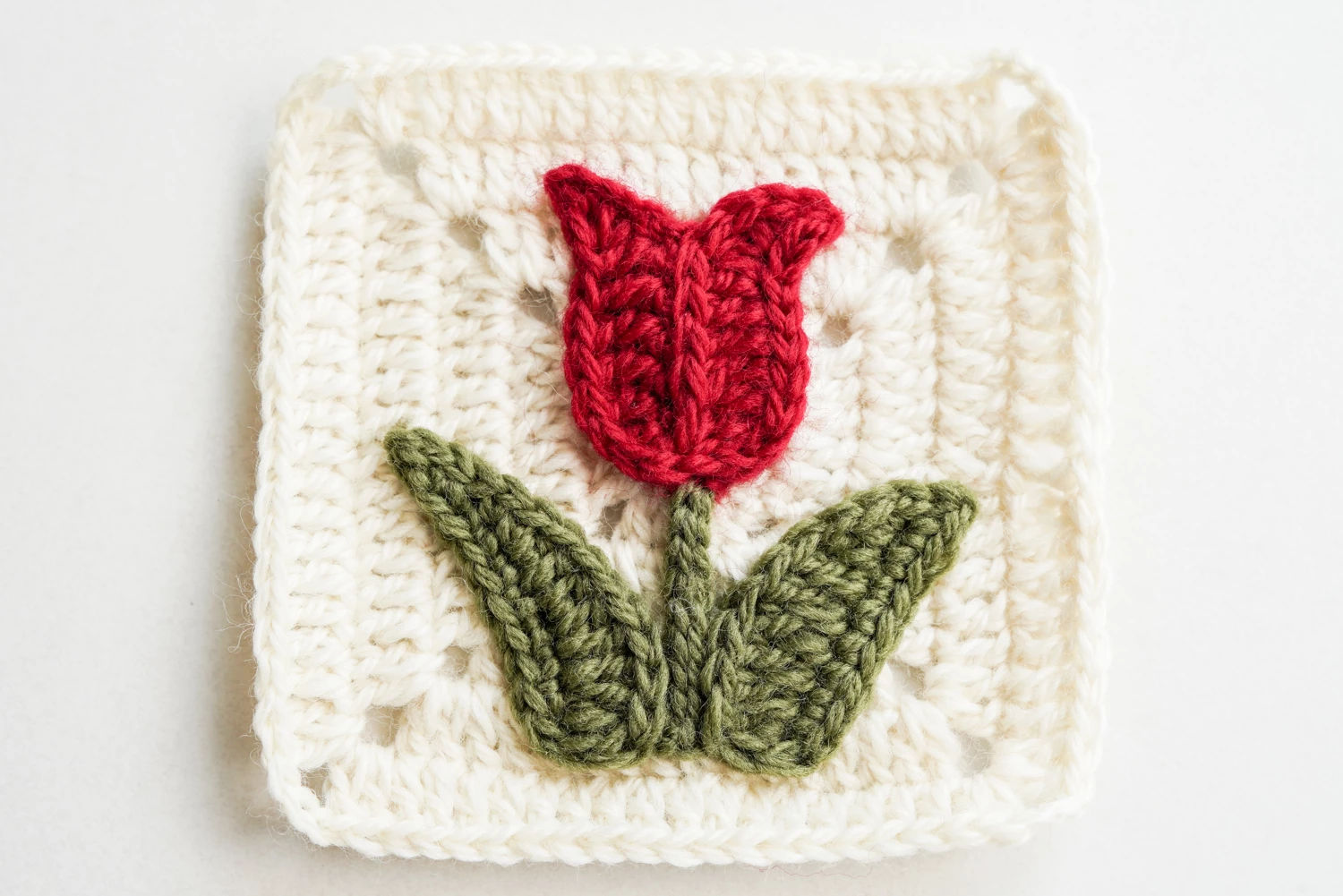 Assembling the tulip motif onto the completed granny square background