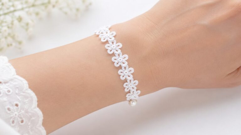Crochet flower bracelet pattern finished on a wrist, white daisy chain band