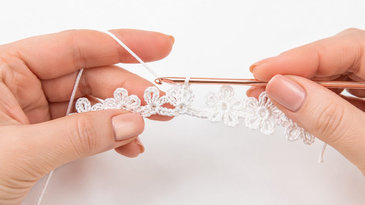 Row 1 of the crochet flower bracelet in progress, top petals being added
