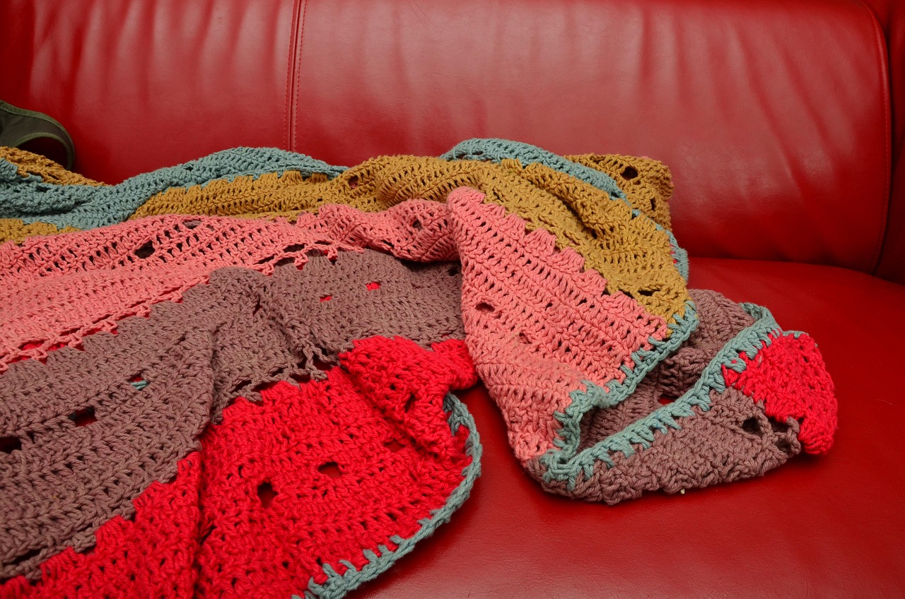 Crochet blanket draped on sofa