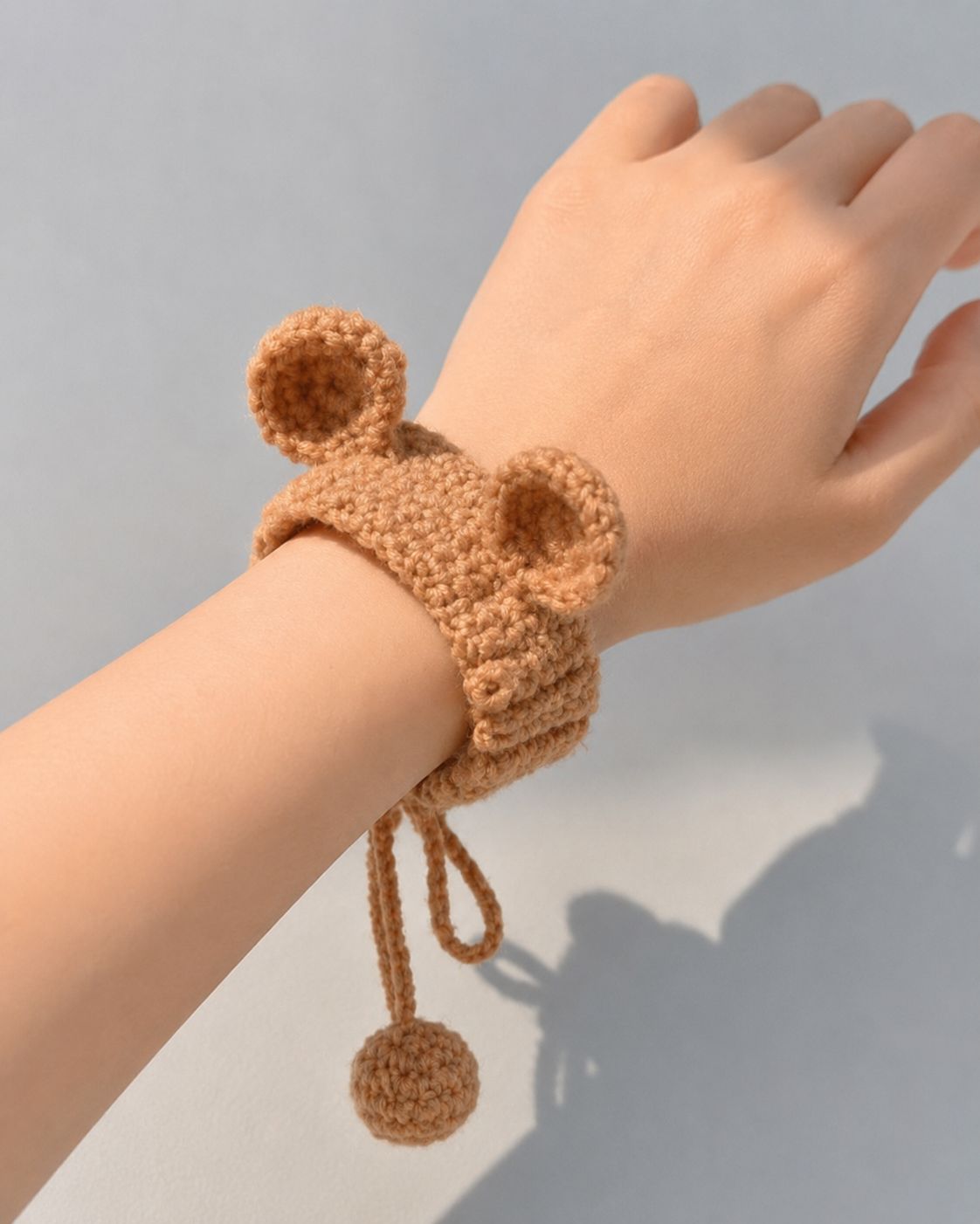 Crocheted bear ear bracelet with pom pom detail