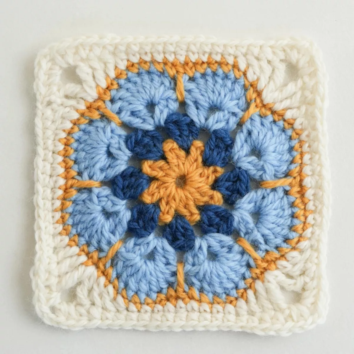 Completed african flower granny square showing round by round color changes in hexagonal motif