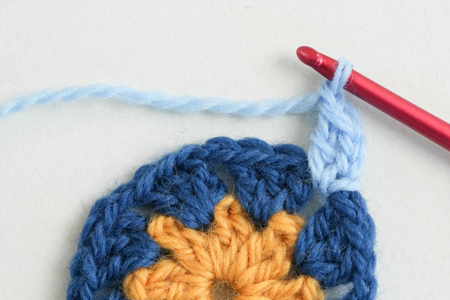 Completed african flower granny square showing all 7 rounds with square border