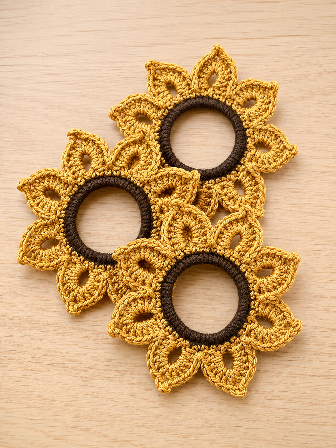 Crochet sunflower scrunchies in gold and brown yarn