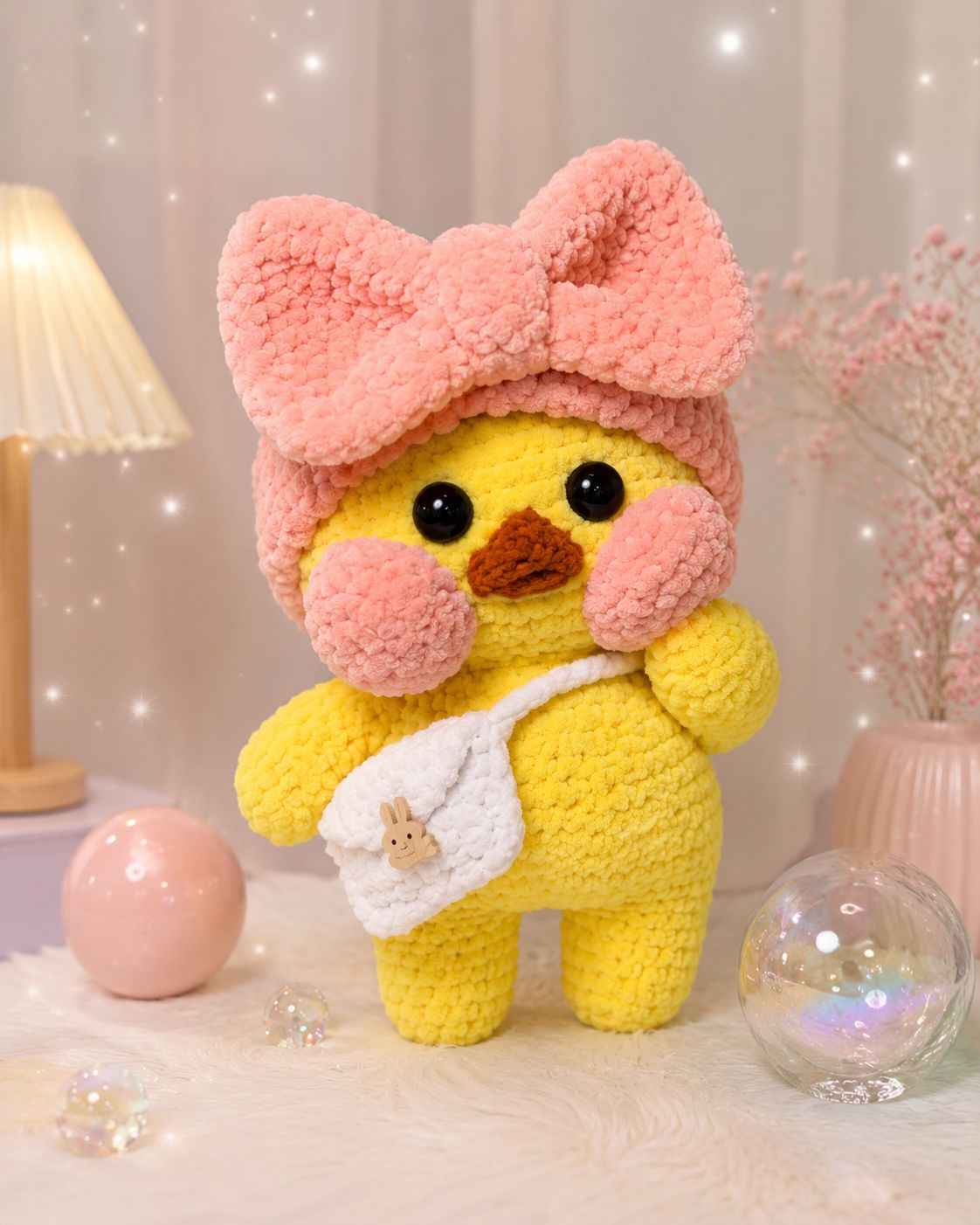 Yellow duck with large pink bow headband and white bag with bunny charm plush toy