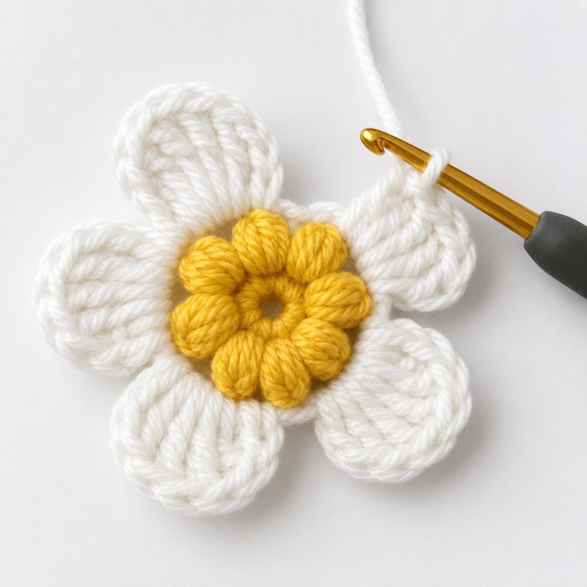 Round 3 in progress: white rounded petals being added around the finished yellow bobble center