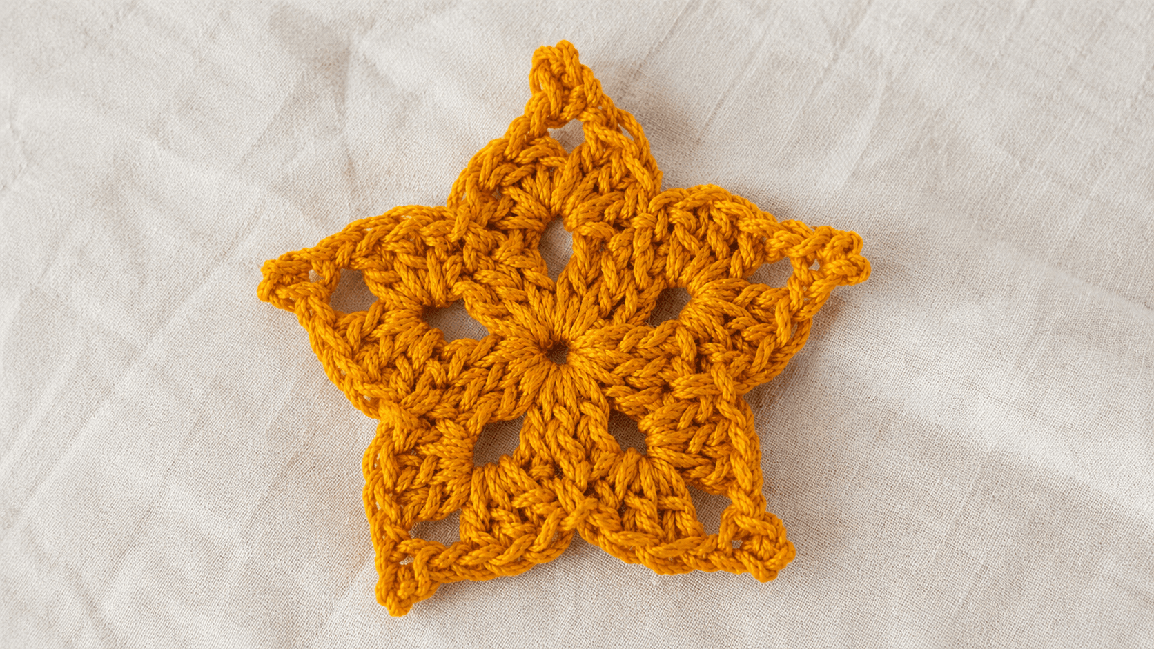Single yellow handmade crochet star applique