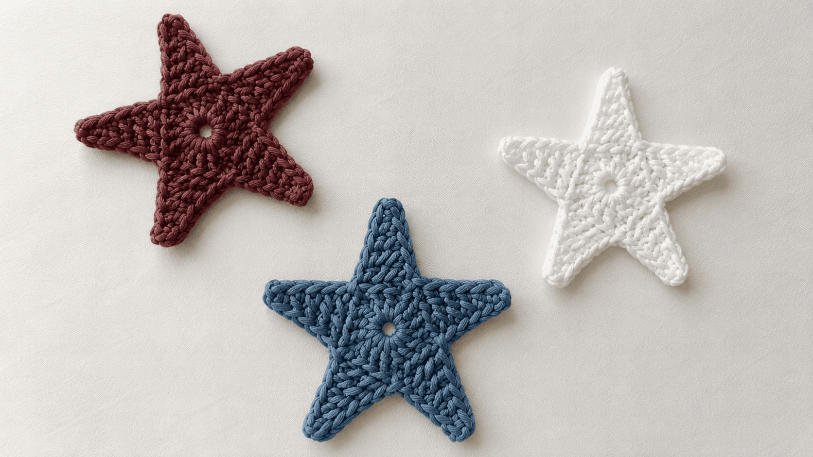 Three handmade five-point crochet star appliques
