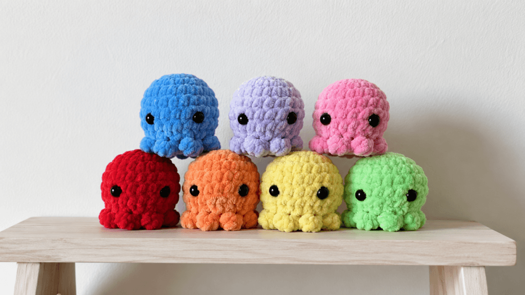 Collection of colorful plush crocheted octopuses with curled tentacles