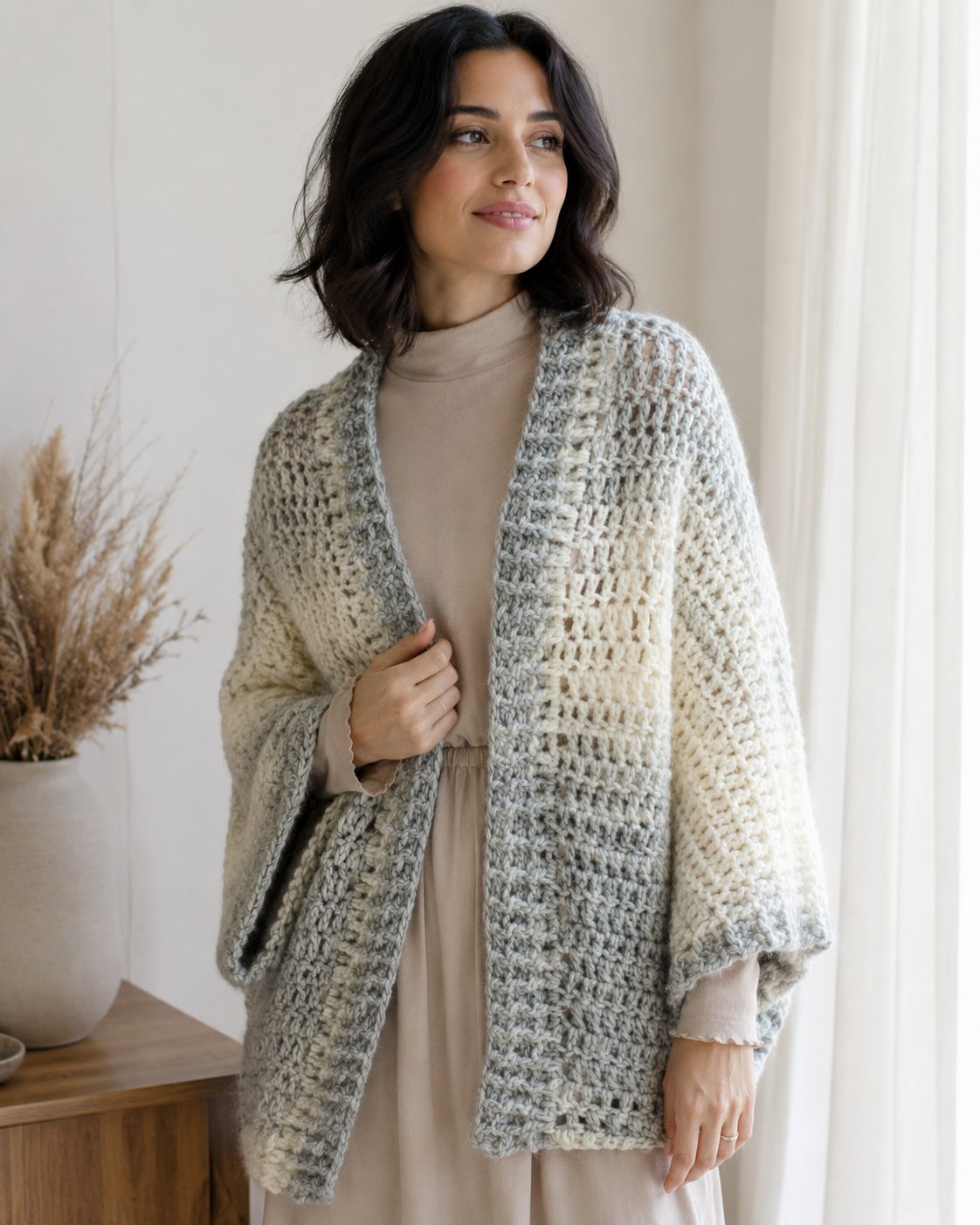 Chunky marled grey and cream crochet shrug with dense fabric and deep sleeves