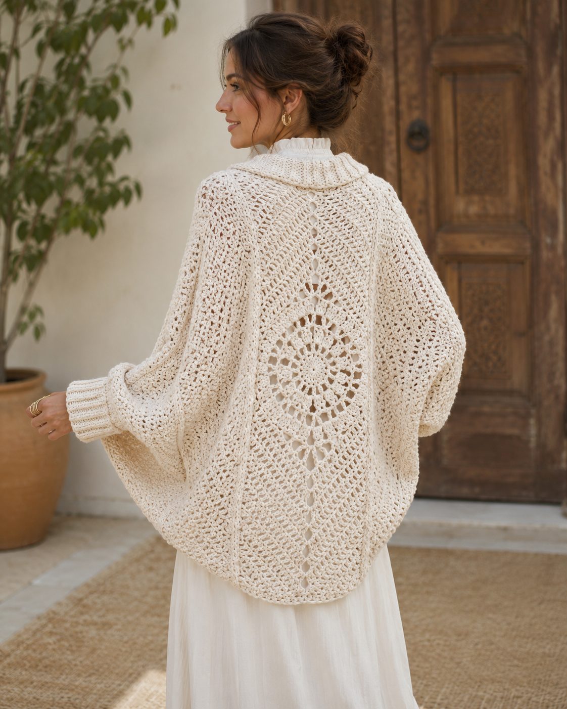 Cream crochet shrug with a large circular medallion across the back and batwing sleeves