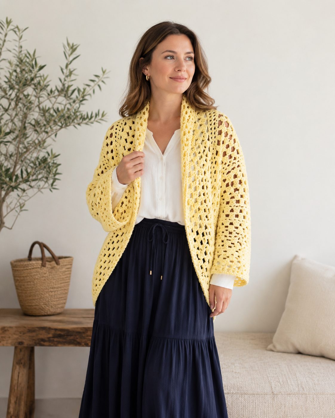 Pale yellow openwork crochet cocoon shrug worn open over a white shirt