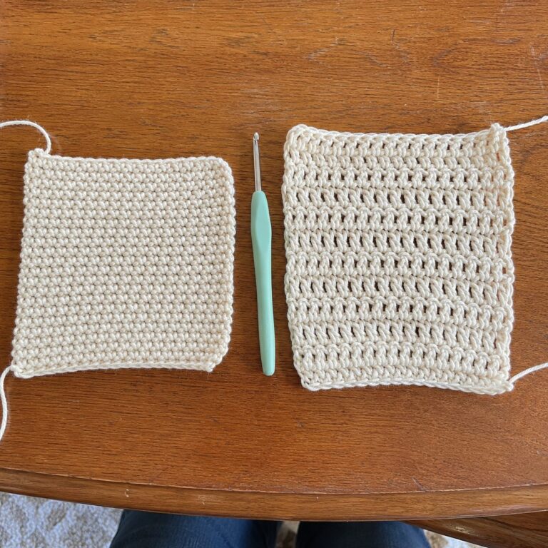 Two handmade crochet swatches side by side on a wooden table showing single crochet on the left (dense fabric) and double crochet on the right (taller, more open) in cream cotton with a mint crochet hook between them