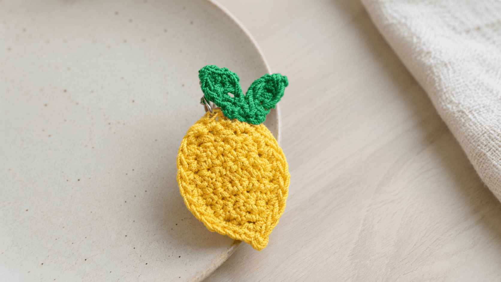 Small crochet lemon keychain with leaf