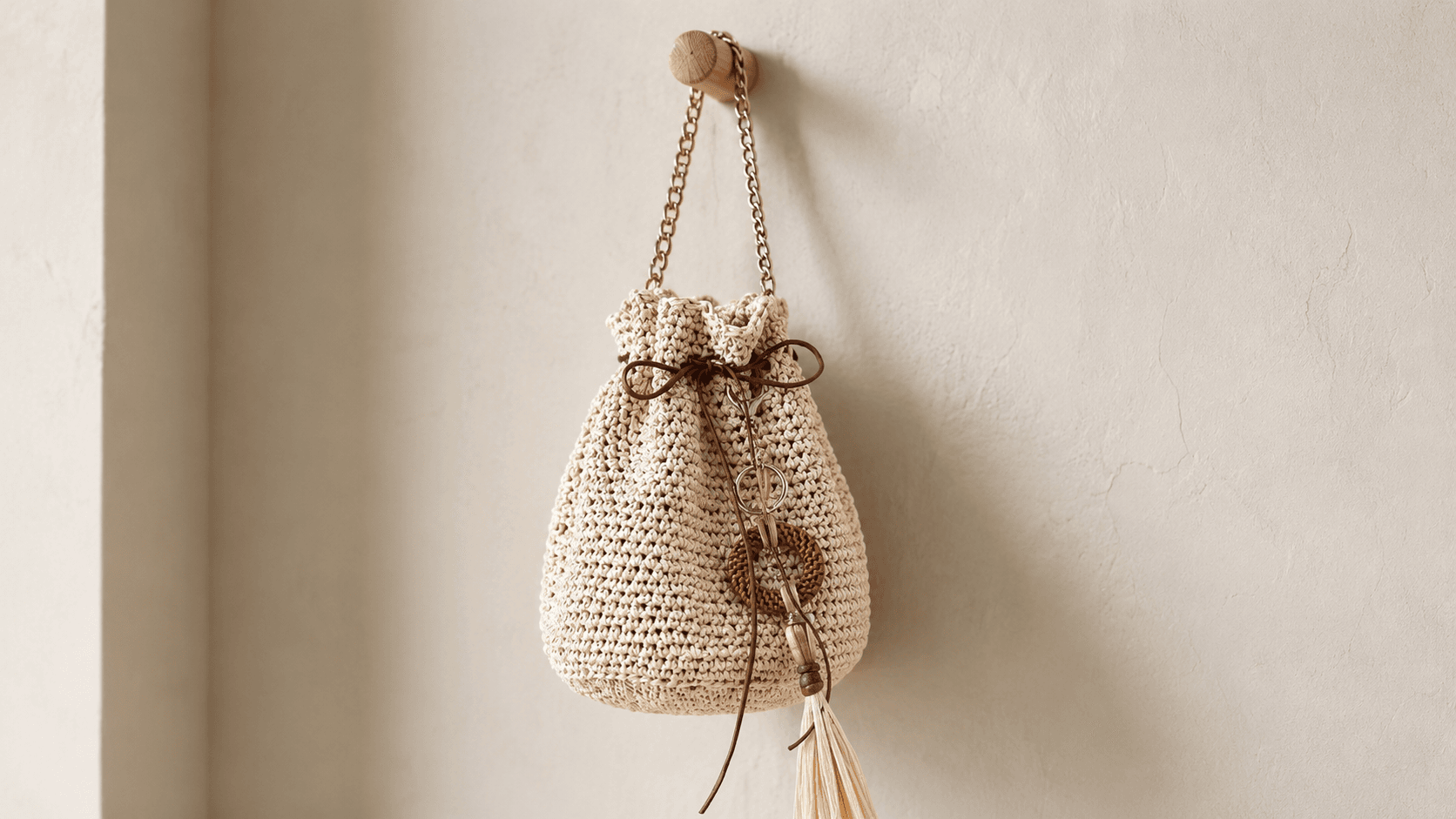 Natural raffia crochet drawstring bag worn crossbody