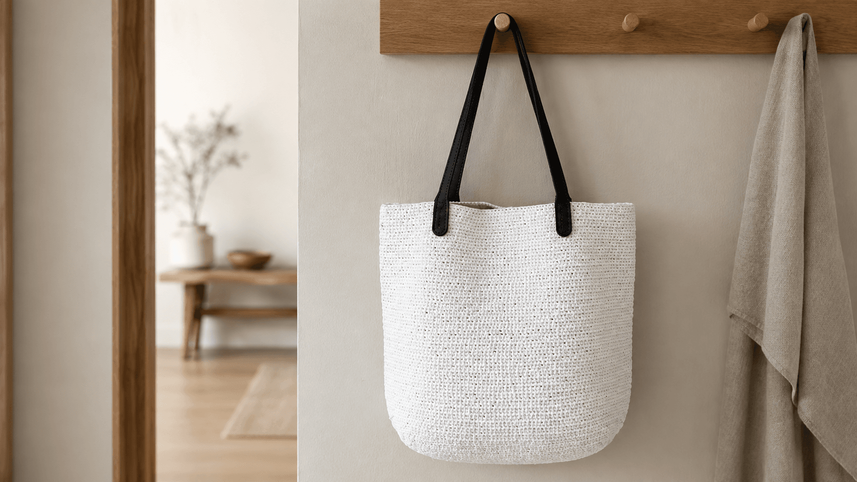 White and cream straw-look crochet tote bag with black handles