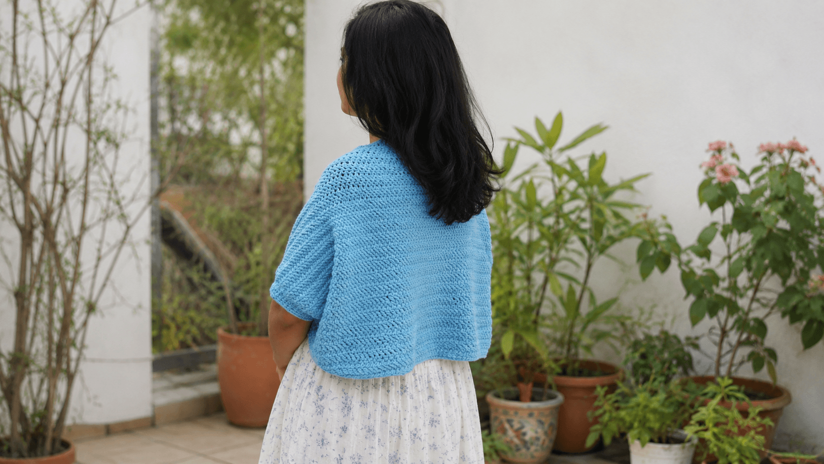 Bright turquoise blue crochet herringbone shrug, floral dress, outdoor market