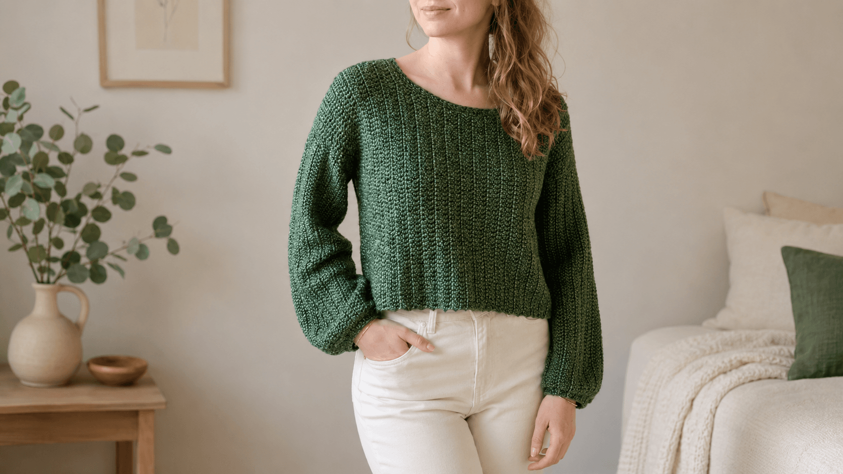 Woman wearing a green cropped crochet sweater with balloon sleeves