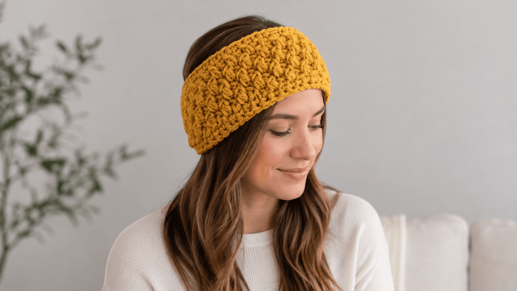 Mustard chunky crochet alpine stitch headband worn by a woman