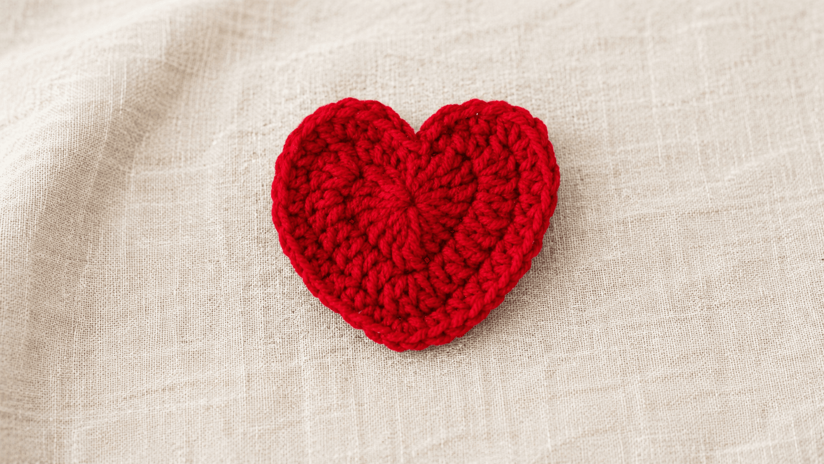 Red crochet heart on cream linen