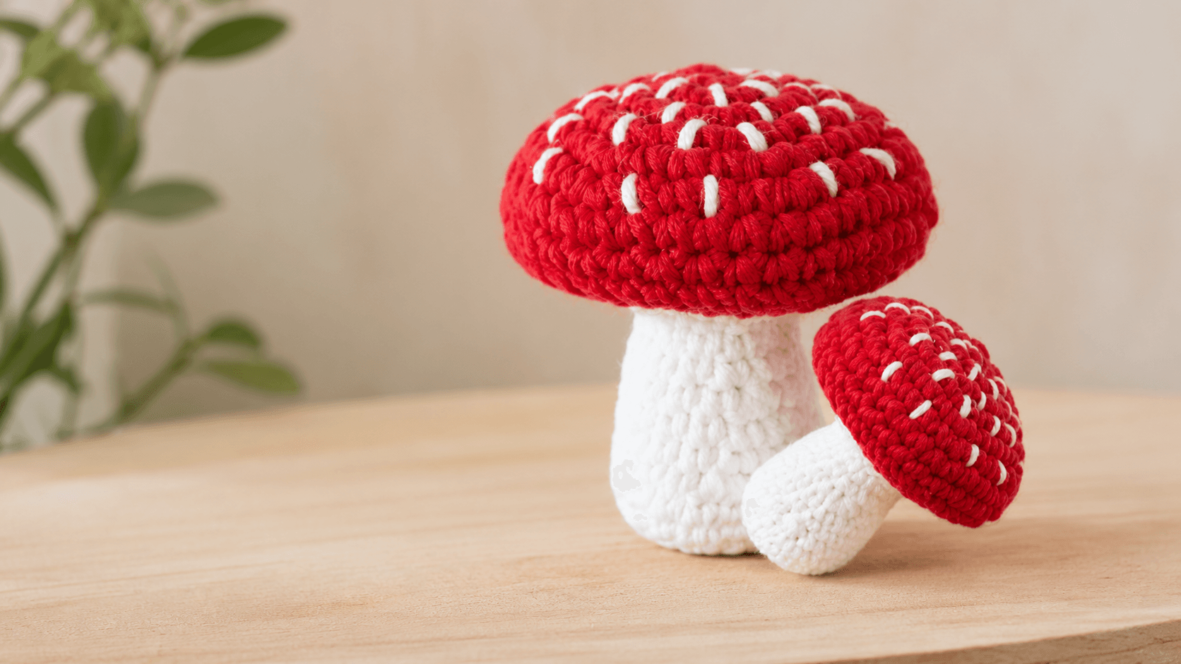 Red and white crochet amigurumi mushroom cluster with fine stitch detail