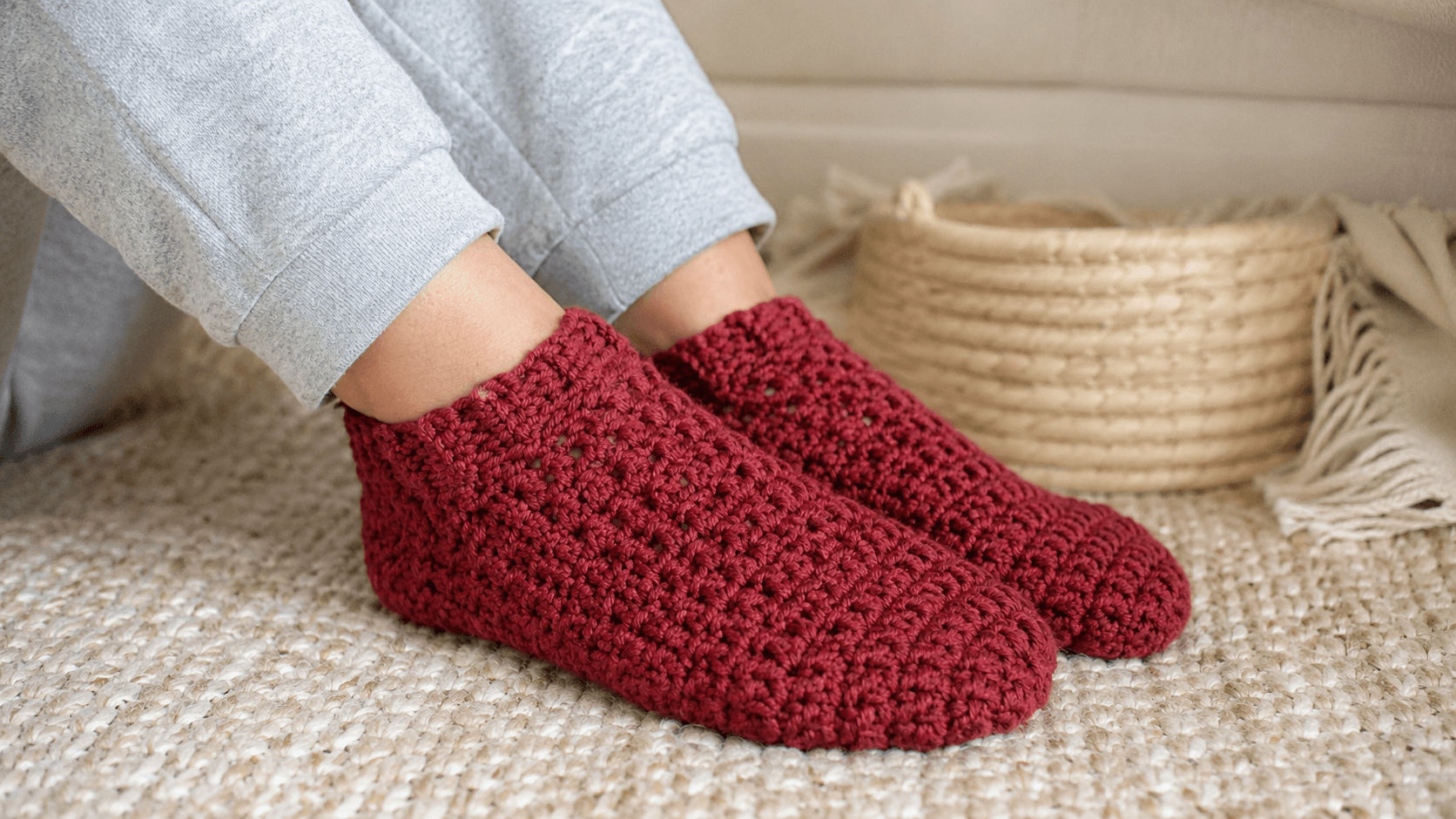 Burgundy crochet slipper socks on feet